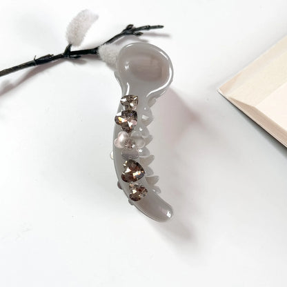 Grey matte banana clip with heart-cut crystals for women