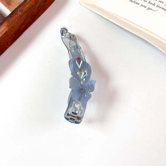 Blue iridescent lock banana clip with flower and crystal detail