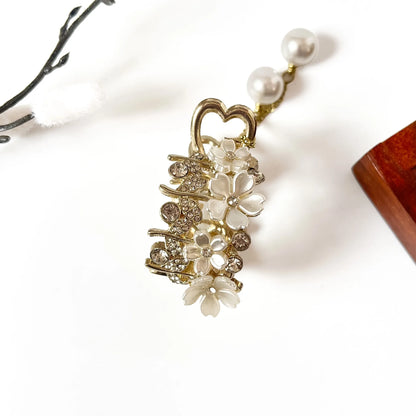 Ivory pearl heart pony cuff with white floral details, pearls, and rhinestones on gold