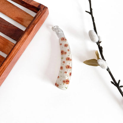 Orange/peach floral print lock banana clip with dense flower pattern, 10cm