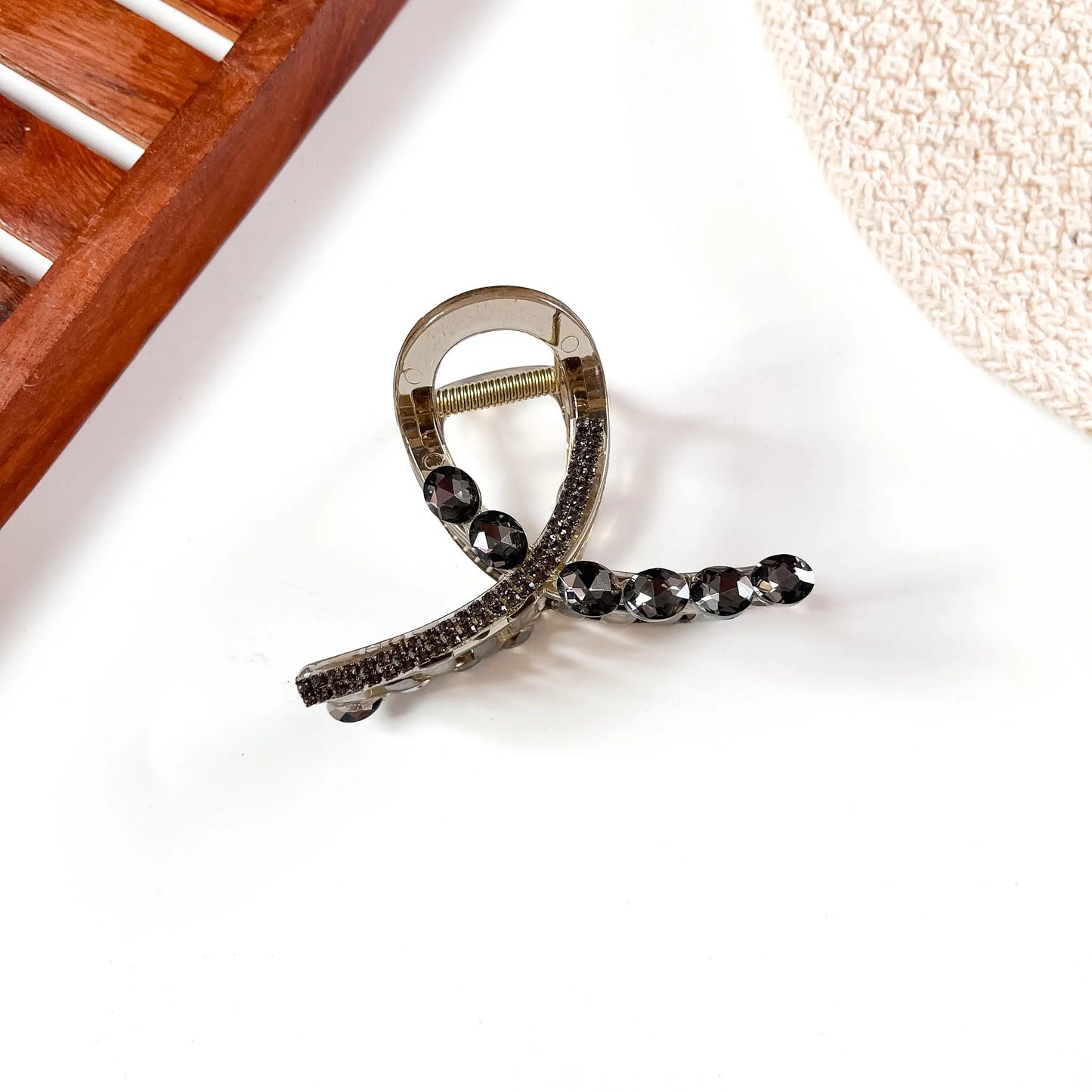 Smoky black large stone claw clip featuring champagne crystal accents and dark metallic claw grip