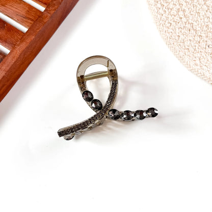 Smoky black large stone claw clip featuring champagne crystal accents and dark metallic claw grip