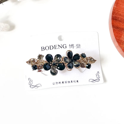 Noir black crystal flower hair clip with antique gold leaves, an elegant rhinestone barrette for buns
