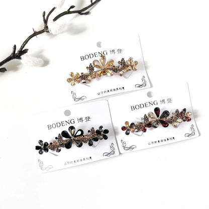 Meadow Bloom crystal flower and butterfly barrettes in champagne gold, noir black and harvest multicolour