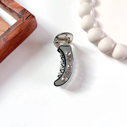 Grey acrylic minimal banana clip with faceted heart gem and rhinestone accents, 5cm
