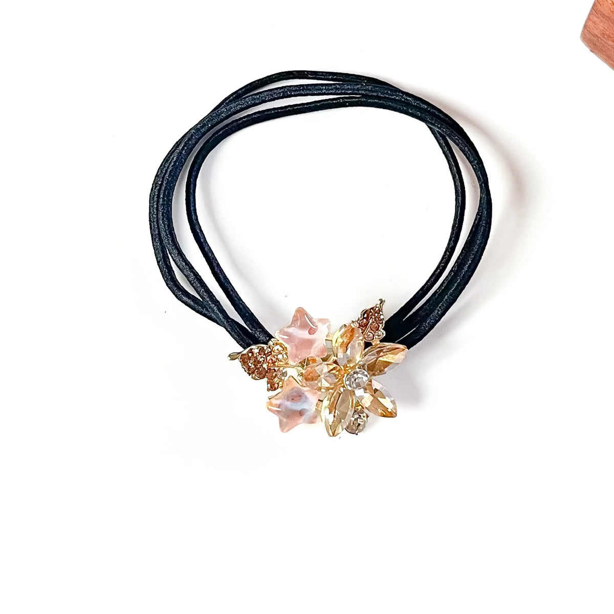 Nectar peach fancy rubber band for hair with champagne crystal flower and pink star charms