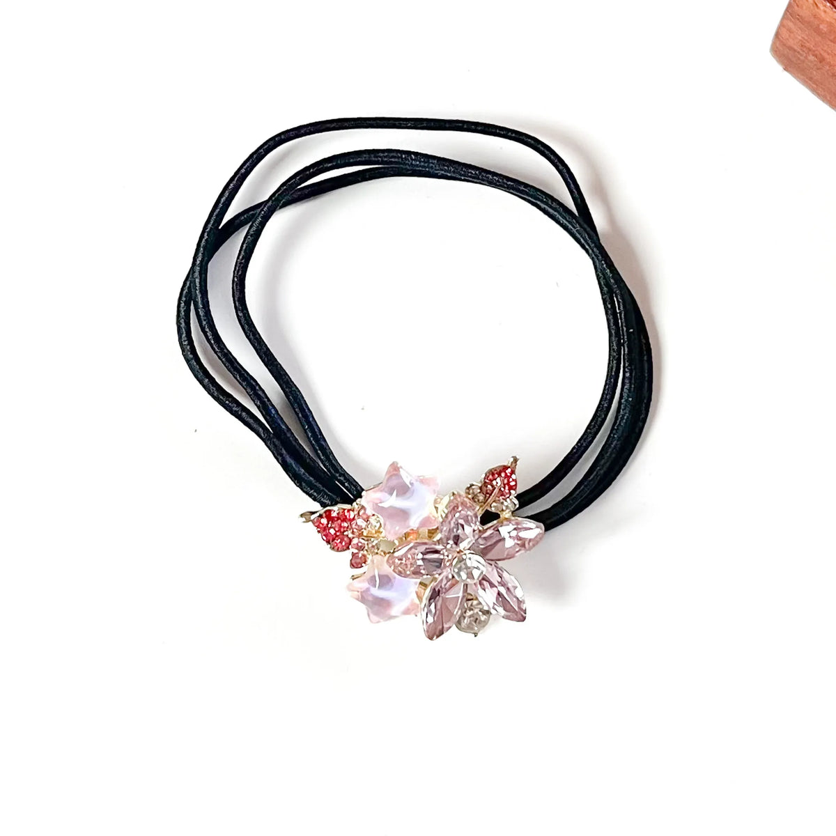 Orchid pink flower hair tie with pink crystal petals, blush star charms and red rhinestone leaves