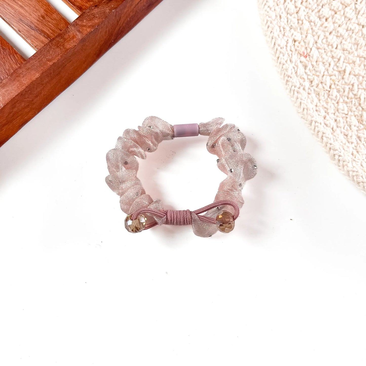 Dusty pink organza scrunchie with silky elastic band, crystal beads, and voluminous gathered mesh texture.