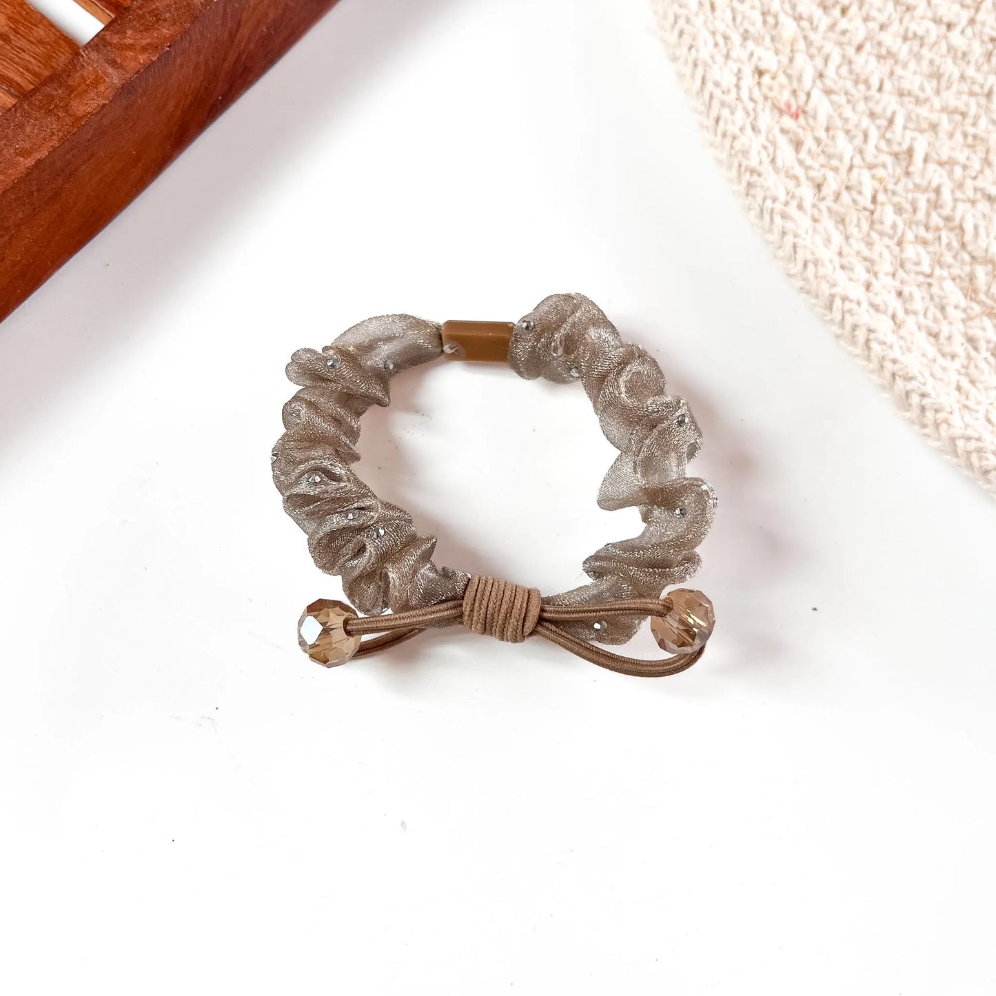 Rose gold metallic organza scrunchie with textured mesh body and champagne crystal bead drops