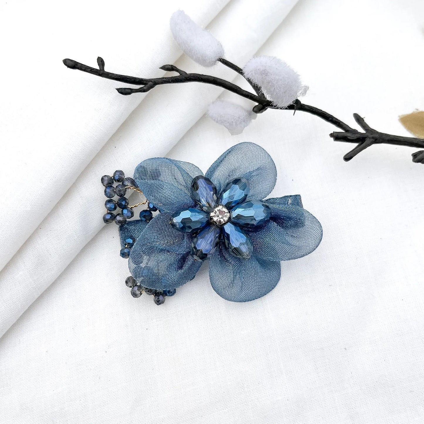 Blue ornate alligator clip with layered mesh petals, crystal faceted flower and berry clusters, 