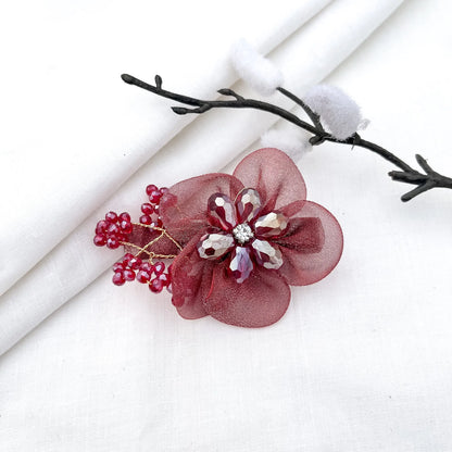 Deep red/maroon ornate alligator clip with mesh petals, faceted crystal flower and gems,