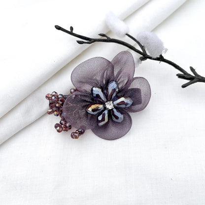 Mauve ornate alligator clip with mesh petals, crystal flower center and faceted beads,