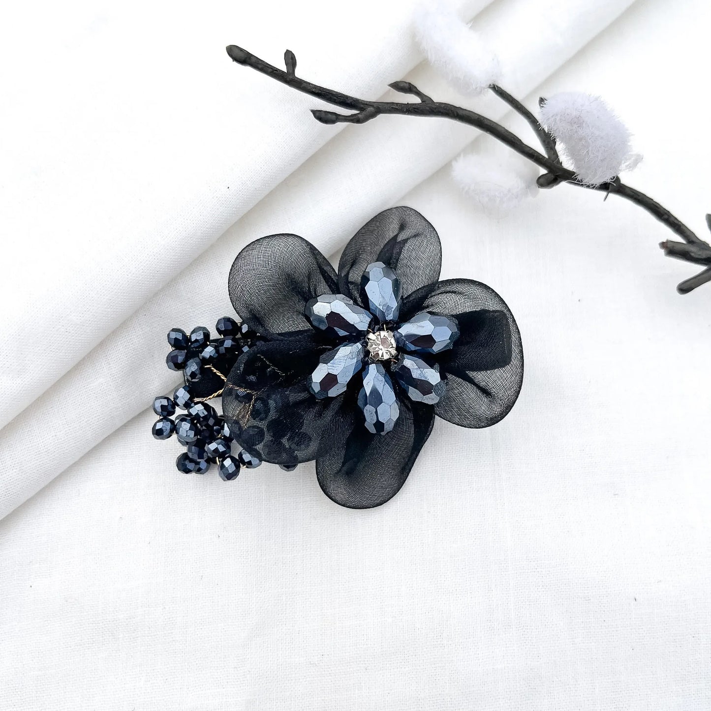 Black ornate alligator clip with layered mesh petals, crystal flower and berry clusters,