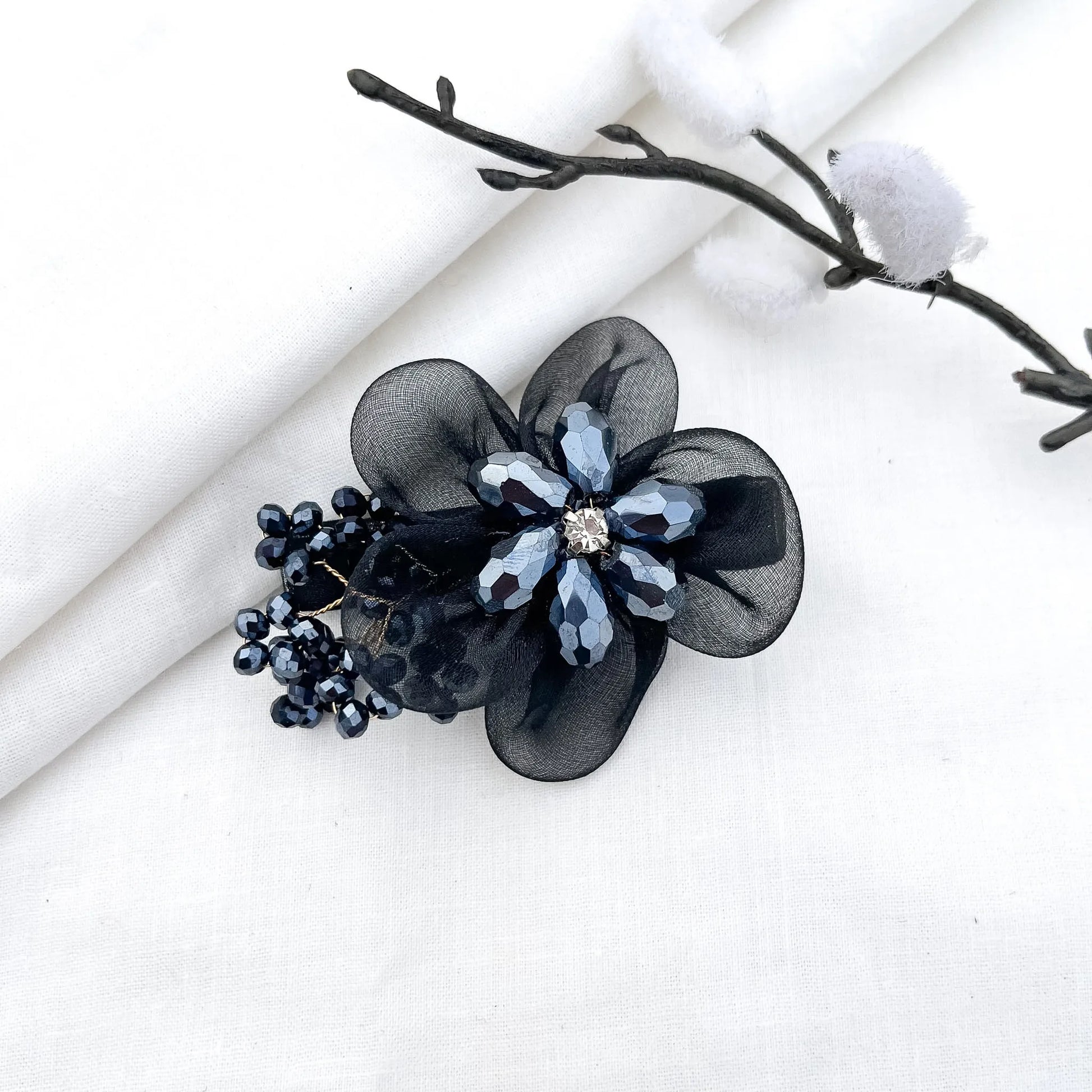 Black ornate alligator clip with layered mesh petals, crystal flower and berry clusters,