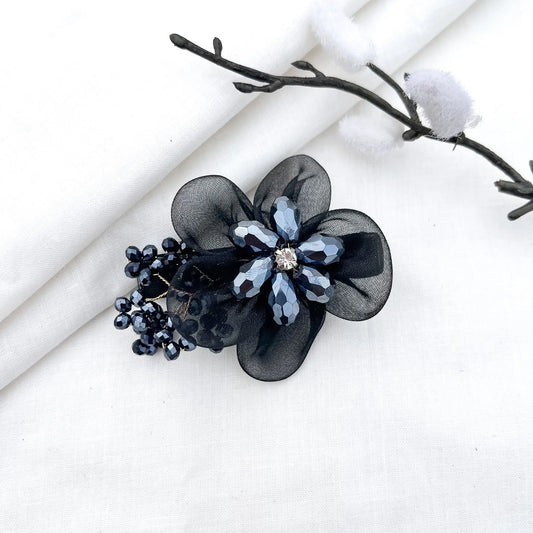 Black ornate alligator clip with layered mesh petals, crystal flower and berry clusters,