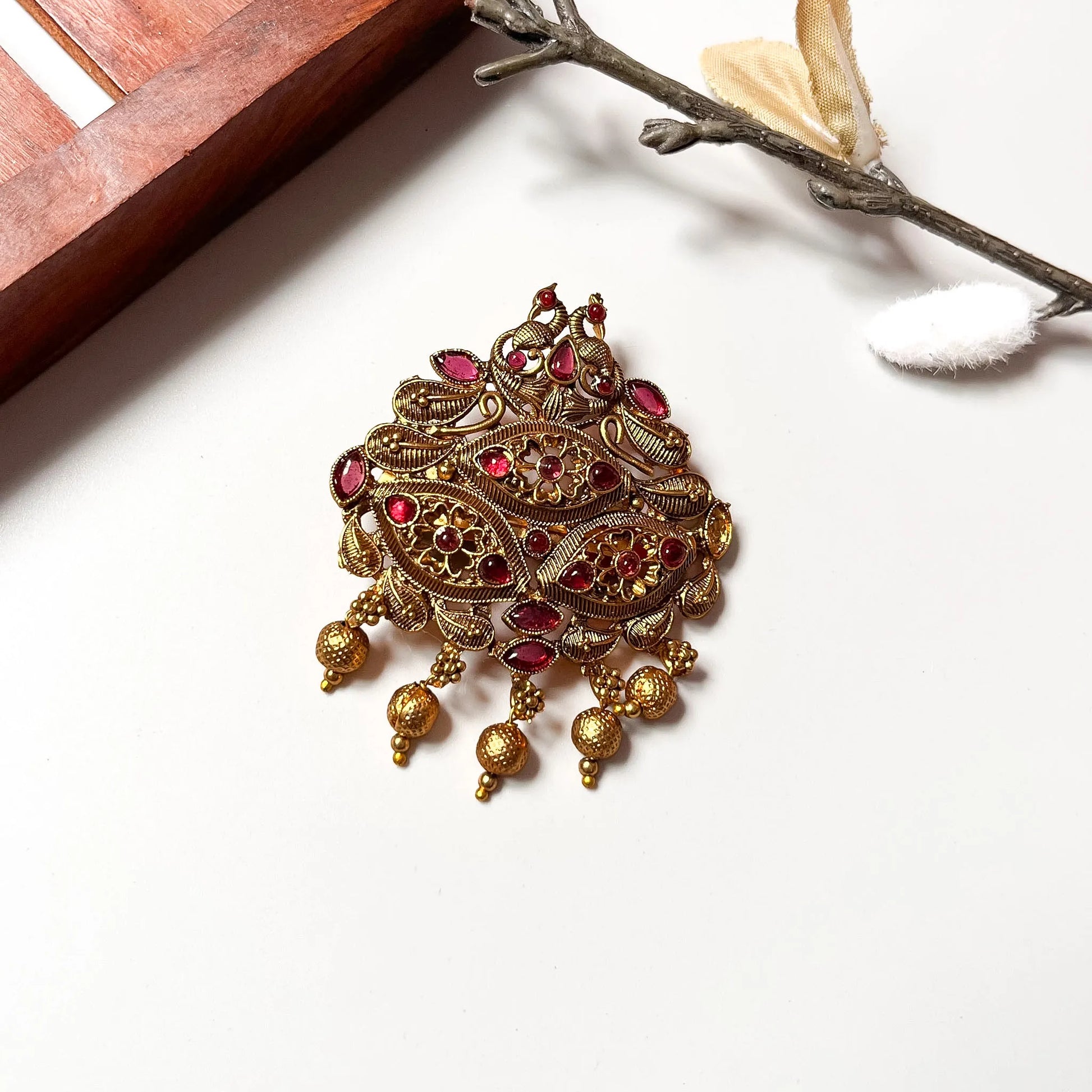 Vintage peacock hair clip with crimson red gemstones, ornate gold filigree design