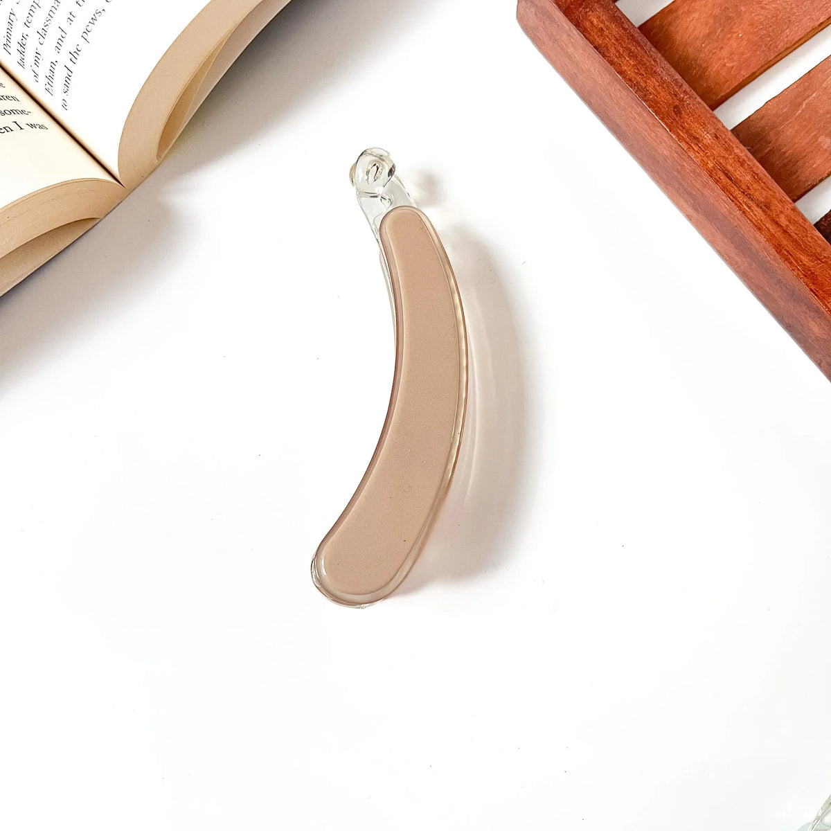 Warm cognac brown banana clip with sleek resin design, minimalist accessory