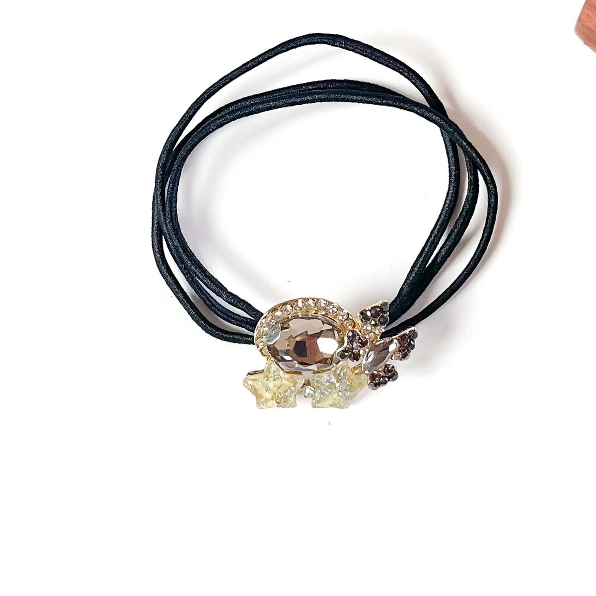 Pewter grey fancy rubber band for hair with smoky oval crystal, grey butterfly and cream stars