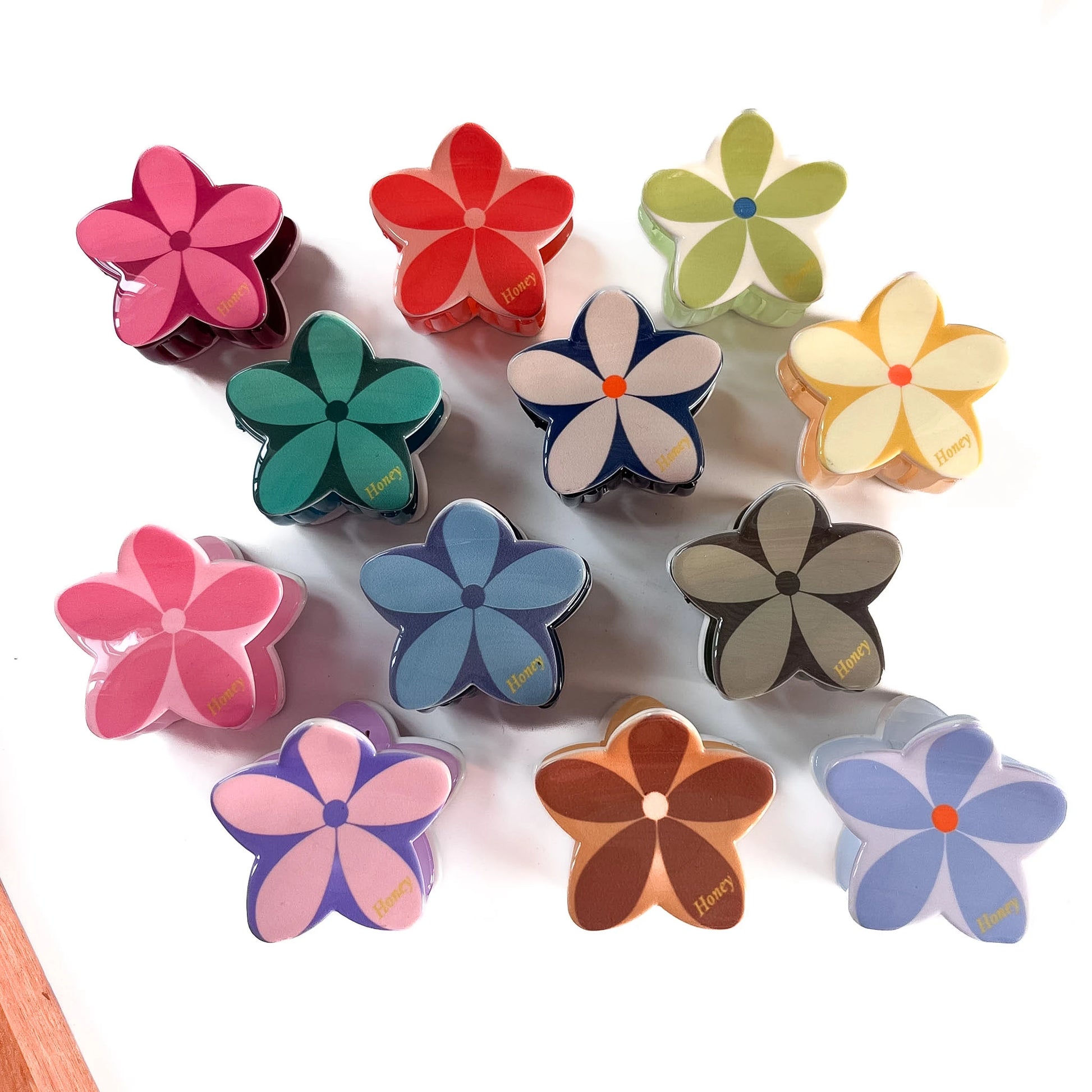 Plumeria flower claw clips in 12 colours including hot pink, red, teal, navy, yellow and bubblegum pink