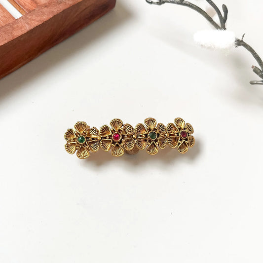 Antique gold flower barrette with four flowers and red and green kemp stones