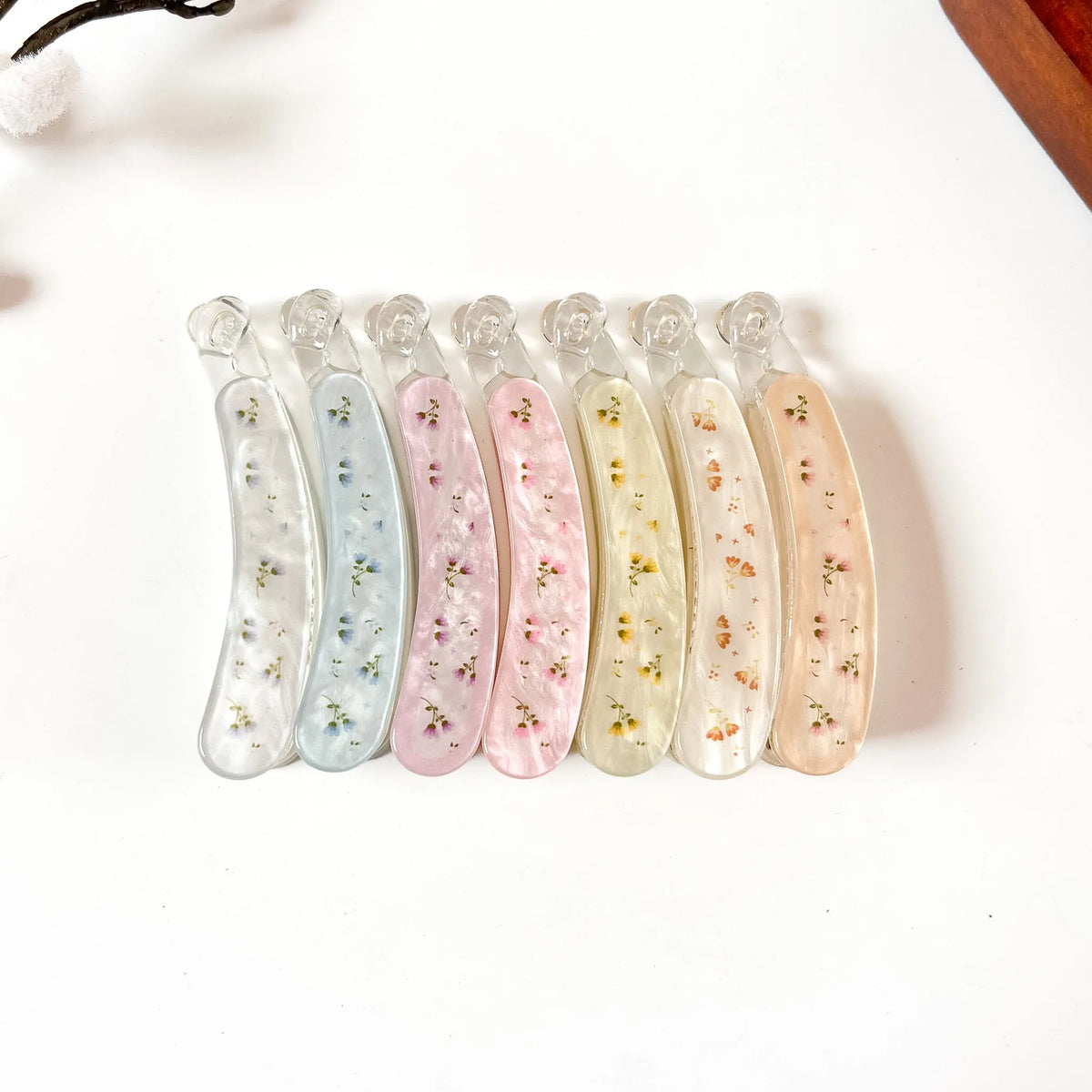 Set of 6 large pressed flower lock banana clips with genuine dried flowers in resin. Colors: ivory white, slate blue, blush pink, rose pink, cream yellow, sunflower orange, peach tan. Secure locking closure. 8cm size perfect for thick hair, curly hair, and fine hair. Botanical fancy banana hair clips.