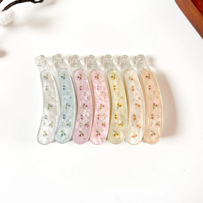 Set of 6 large pressed flower lock banana clips with genuine dried flowers in resin. Colors: ivory white, slate blue, blush pink, rose pink, cream yellow, sunflower orange, peach tan. Secure locking closure. 8cm size perfect for thick hair, curly hair, and fine hair. Botanical fancy banana hair clips.