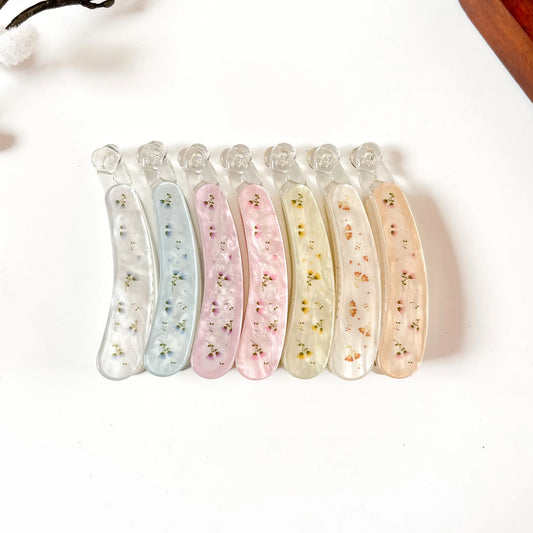 Set of 6 large pressed flower lock banana clips with genuine dried flowers in resin. Colors: ivory white, slate blue, blush pink, rose pink, cream yellow, sunflower orange, peach tan. Secure locking closure. 8cm size perfect for thick hair, curly hair, and fine hair. Botanical fancy banana hair clips.