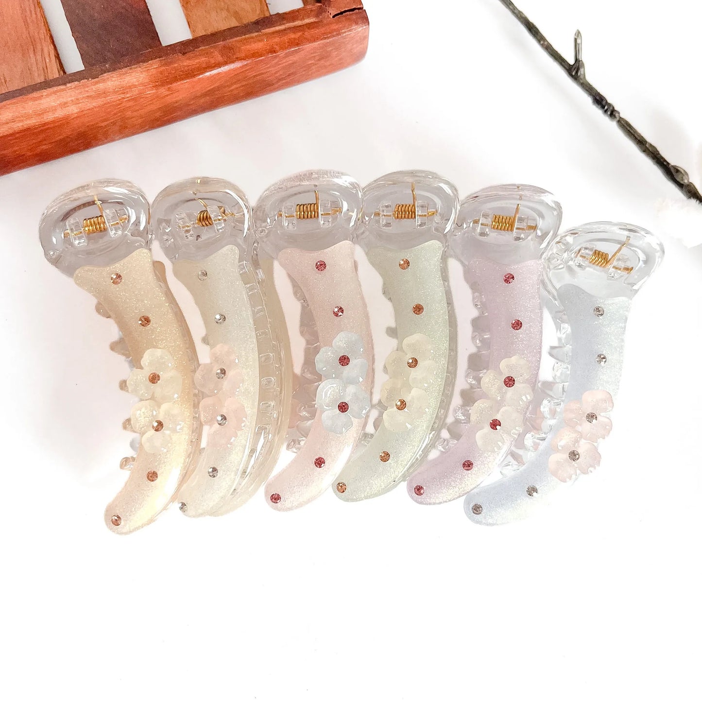 All 6 radiant flower clips: beige, white, peach, mauve, sage, grey with flower petals