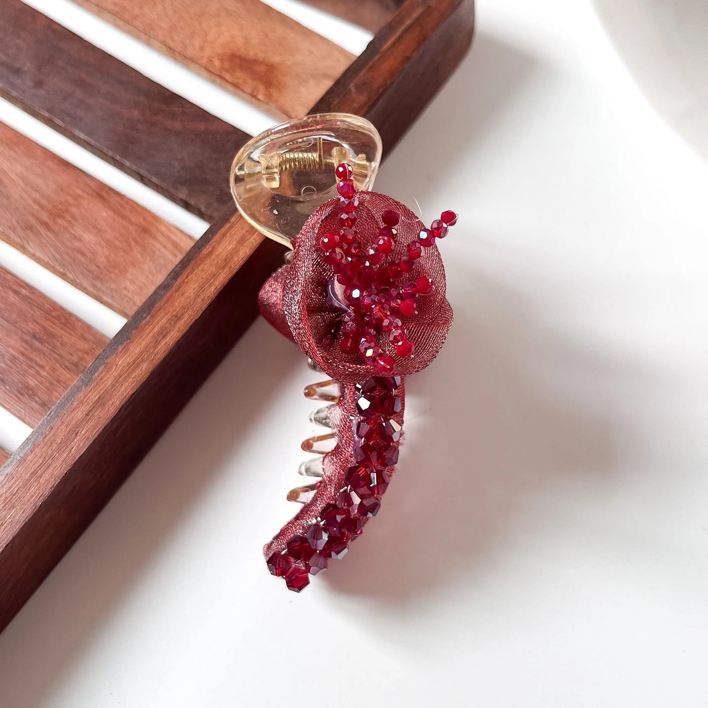 Red rosette crystal banana clip with organza fabric rose and red crystal bead cascade