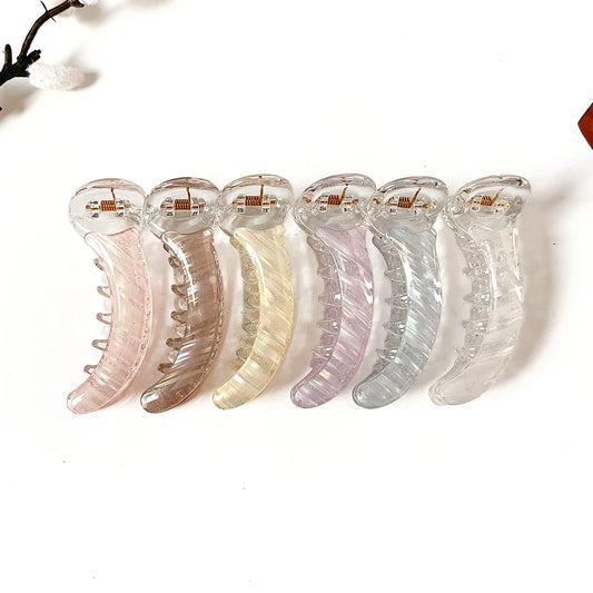 Shimmer Swirl 8 cm clear banana hair clips in blush pink, mocha brown, butter yellow, lilac purple, frost blue and crystal clear with glitter swirl