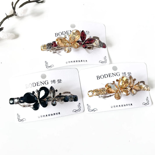 Silk Wing crystal butterfly barrettes in noir black, champagne gold and harvest multicolour