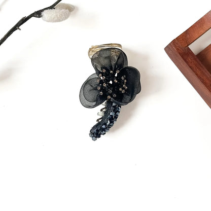 Starburst Bloom Banana Clip in onyx black, 8cm floral banana clutcher with black crystal stones