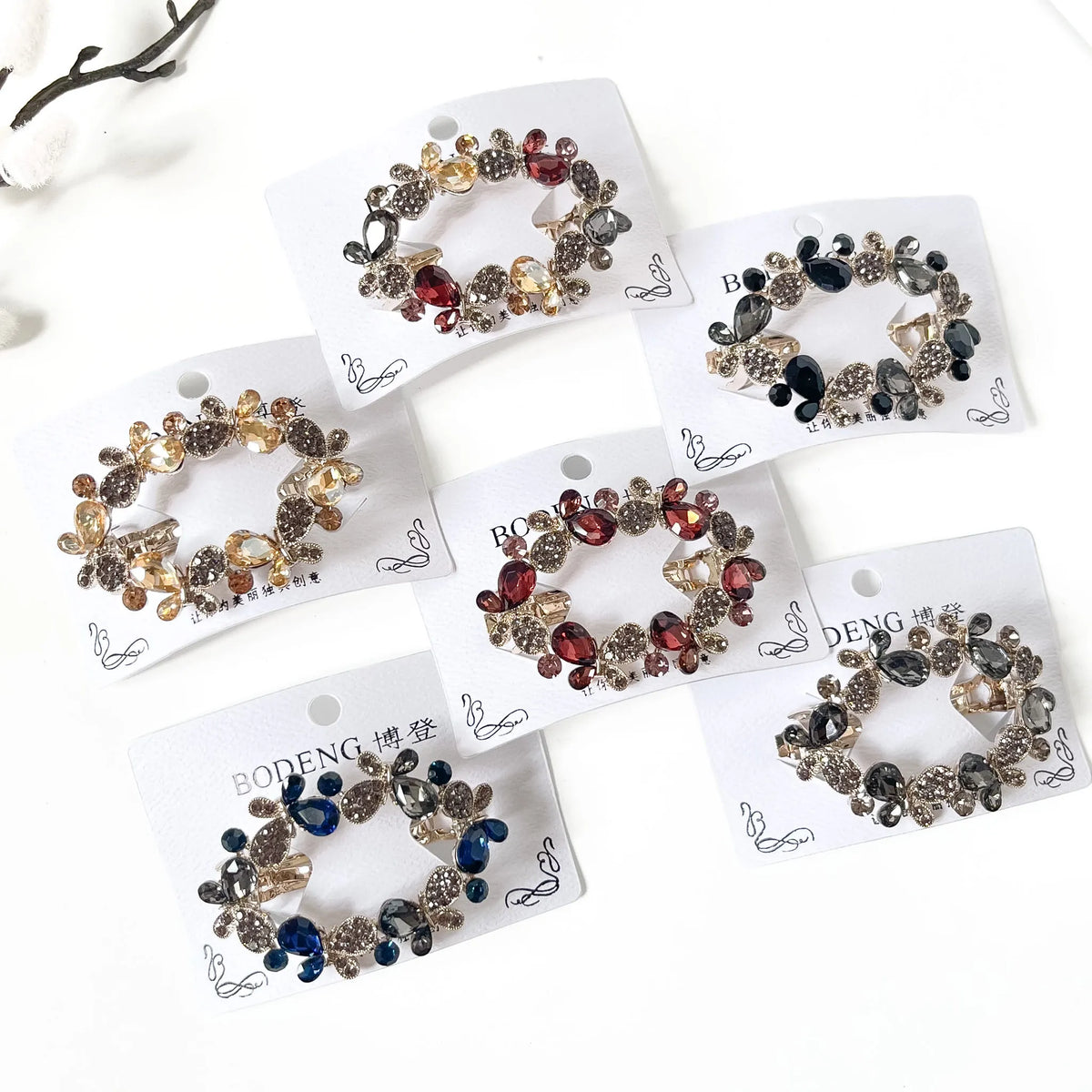Titli crystal butterfly barrettes in champagne gold, slate grey, harvest multicolour, noir black, sapphire navy blue and merlot burgundy