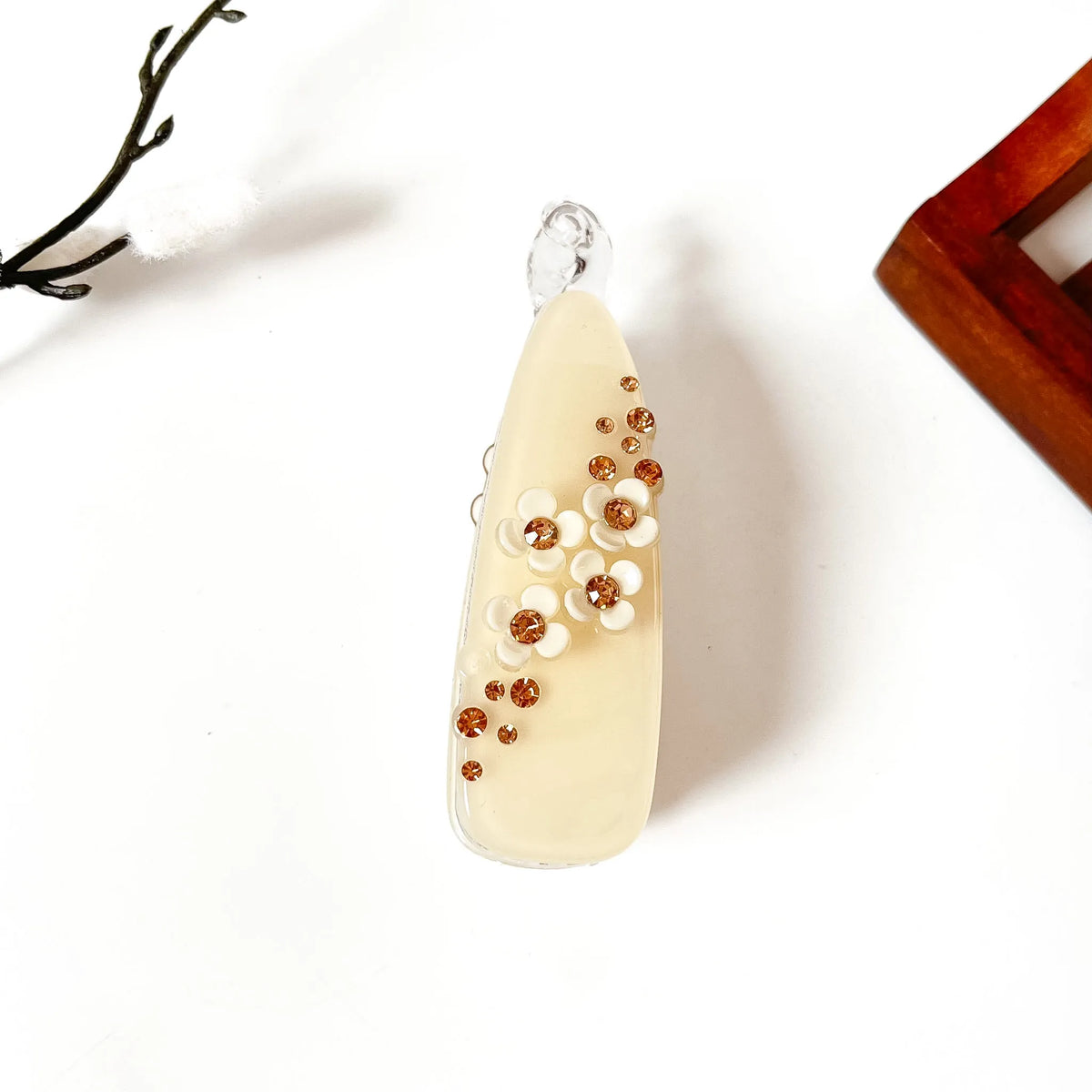 Vanilla cream teardrop banana clip with amber scattered gems and white flower center, large size